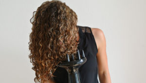 girl blowdrying her hair with a diffuser